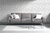 A modern living room with a gray sofa and a textured white wall. Produktbild-Vorschau