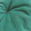 A close-up view of a tufted green cushion, showing the texture of the fabric and the stitching. Produktbild-Vorschau
