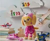 A collection of Paw Patrol toys displayed on shelves and a table, with a plush Skye toy as the main focus. Podgląd zdjęcia produktu