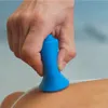 A hand holding a blue suction cup massager on a person's back. Produktbild-Vorschau