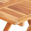 A close-up view of a wooden table surface and its legs. Produktbild-Vorschau