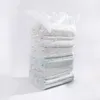 A stack of vacuum-sealed bags filled with bedding, presented against a white background. Produktbild-Vorschau