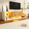 A modern white and wood entertainment center with LED lighting and a TV displayed above it. Voir les images du produit