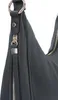 A close-up view of a black leather handbag. Voir les images du produit