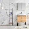 A clean, modern bathroom scene featuring a vanity with a sink and storage, a ladder shelf with toiletries, and marble-tiled walls. Produktbild-Vorschau