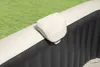 Close-up of a beige headrest attached to the side of an inflatable hot tub, with a green grassy background. Náhľad obrázku produktu