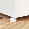 A close-up view of a white rolling caster wheel attached to the bottom of a white furniture item, resting on a brown and white patterned rug. Náhľad obrázku produktu