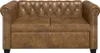 A brown Chesterfield sofa is shown from the front against a white background. Náhled obrázku produktu