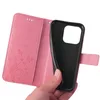 A hand holding a pink floral flip phone case open, revealing the black interior where a phone would be placed. Produktbild-Vorschau