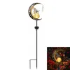 A solar garden light shaped like a crescent moon with a fairy and a crystal hanging from it, shown against a white background. Produktbild-Vorschau