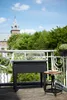 A balcony with a raised garden bed and a small stool. Náhled obrázku produktu