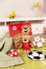 A collection of FC Bayern Munich themed children's items, including plush toys, a pillow, and soccer balls, arranged on a green rug. Náhľad obrázku produktu
