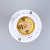 A close-up, top-down view of a white E27 lamp socket adapter with gold-colored electrical contacts. Podgląd zdjęcia produktu