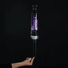 A hand is holding a vacuum cleaner on a black background. Voir les images du produit