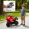 A child standing next to a red toy motorcycle in an outdoor setting. Produktbild-Vorschau