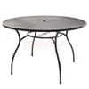 A round metal garden table with a mesh top and four curved legs, shown against a white background.