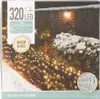 A box of LED net lights with a picture of the lights illuminating a snowy garden scene. Produktbild-Vorschau