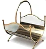 A gold-colored metal firewood basket with a mesh design, shown against a white background. Produktbild-Vorschau