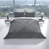A bed with gray bedding featuring a stripe pattern, set against a large window with a view of a landscape. Produktbild-Vorschau