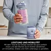 A person is holding a portable blender cup filled with a purple smoothie, with the blender base visible below. Náhled obrázku produktu