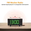 A digital alarm clock with a projected time display sits on a wooden surface. Produktbild-Vorschau