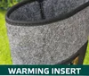 A close-up view of a grey felt boot insert with a black trim, set against a blurred green background. Produktbild-Vorschau