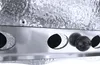 A close-up view of a grill accessory with several circular openings and dark spheres. Produktbild-Vorschau