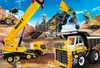 A construction site with various heavy machinery toys, including a crane, dump truck, and excavator, under a blue sky with clouds. Produktbild-Vorschau