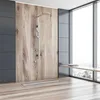 A modern bathroom with a shower, wooden wall paneling, and a large window. Produktbild-Vorschau