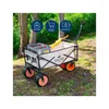 A Falko electric wagon is shown outdoors in a wooded area, loaded with a crate of bottles. Produktbild-Vorschau