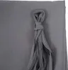 A close-up of a gray fabric with a knotted tassel. Podgląd zdjęcia produktu
