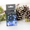 A product box for LED wire lights is shown in a festive, winter-themed setting with pine cones and greenery. Produktbild-Vorschau