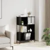 A black bookshelf filled with books and decorative items, placed next to a sofa in a room. Náhled obrázku produktu