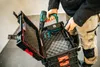 A person is placing a cordless drill into a tool case. Náhled obrázku produktu