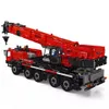 A red and black toy crane model on a white background. Voir les images du produit