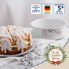 A decorated cake and a springform pan are displayed on a white surface, with Christmas-themed decorations. Anteprima dell’immagine prodotto