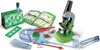 A collection of science exploration tools, including a microscope, petri dish, slides, tweezers, and educational booklets, laid out on a white background. Náhľad obrázku produktu
