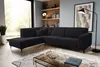 A modern living room with a black sectional sofa, coffee table, and shelves. Voir les images du produit