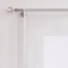 A close-up view of a white sheer curtain hanging from a curtain rod with a decorative antler-shaped finial. Produktbild-Vorschau