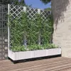A white planter with a trellis filled with green plants, set on a wooden deck next to a brick wall. Voir les images du produit