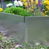 A close-up view of a galvanized metal garden border with flowers in the background. Náhled obrázku produktu