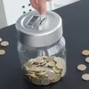 A hand is inserting a coin into a digital piggy bank, which is filled with coins. Náhľad obrázku produktu
