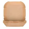 A stack of square, brown paper baking liners for an air fryer. Produktbild-Vorschau
