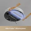 A robot vacuum cleaner is shown from below, with a blue glowing effect highlighting its mopping system and orange liquid splashing around it. Produktbild-Vorschau