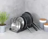A kitchen counter with a pot and pan organizer, a plant, and storage jars. Anteprima dell’immagine prodotto