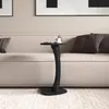 A black marble-look side table with a cup of coffee on it, placed next to a beige sofa in a living room. Podgląd zdjęcia produktu