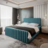 A modern bedroom with a blue upholstered bed as the focal point. Produktbild-Vorschau