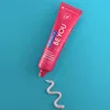 A tube of pink toothpaste with a swirl of toothpaste on a blue background. Náhled obrázku produktu