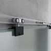 A close-up view of a sliding glass door track system mounted on a concrete wall. Produktbild-Vorschau