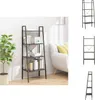 A black ladder shelf with books and decorative items on it, placed next to a white sofa. Podgląd zdjęcia produktu